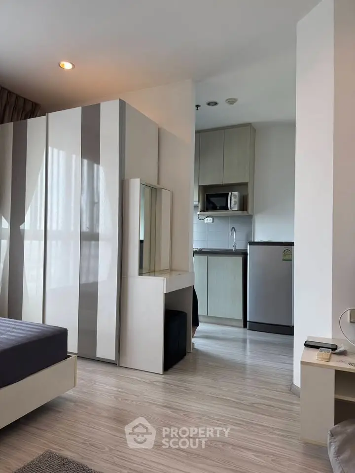 Modern studio apartment with sleek kitchen and stylish furnishings