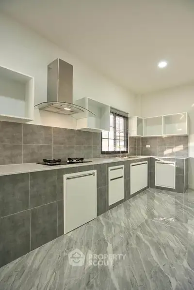 Modern kitchen with sleek cabinetry and gas stove in a stylish open layout