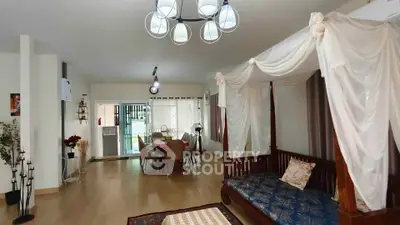 Spacious living room with elegant decor and dining area, perfect for family gatherings.