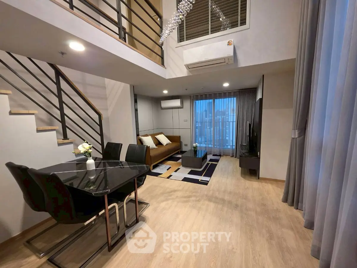 Modern duplex living room with stylish decor and large windows