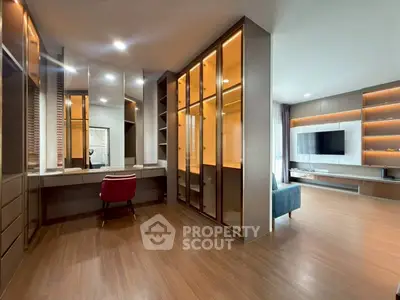 Spacious modern living room with elegant wooden flooring and built-in shelving, perfect for stylish urban living.