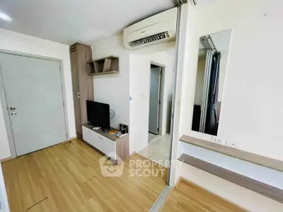 Modern living room with sleek design, featuring wooden flooring and built-in air conditioning.