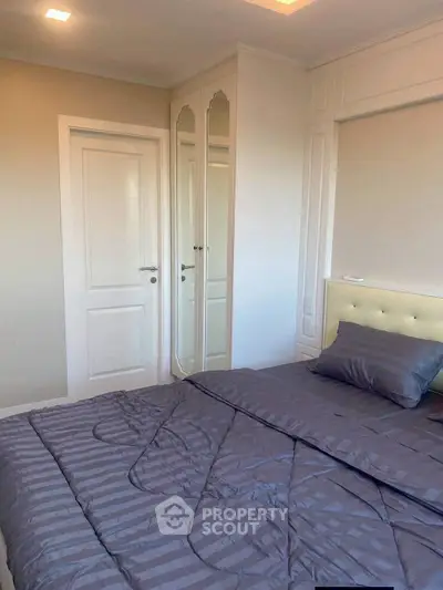 Elegant bedroom with stylish decor and mirrored wardrobe doors