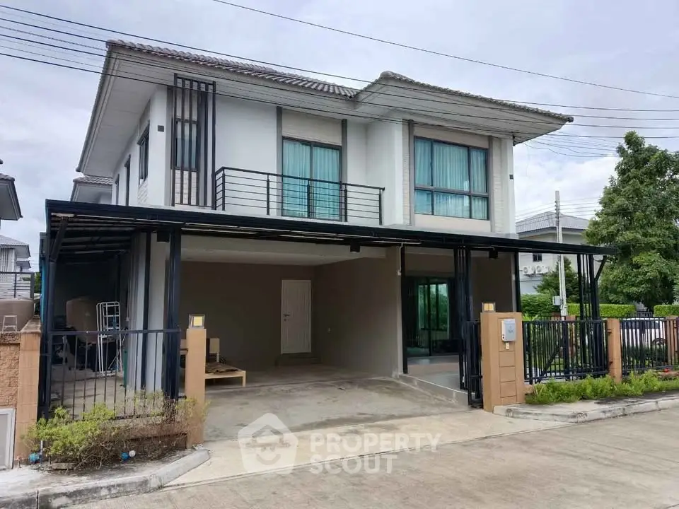Modern two-story house with spacious driveway and sleek design in suburban neighborhood.