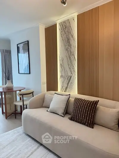 Modern living room with stylish sofa and elegant wall paneling