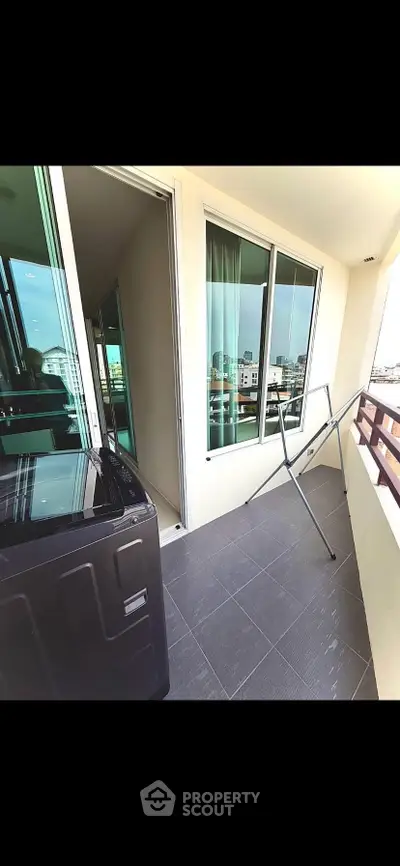 Spacious balcony with city view and modern design, perfect for relaxation and enjoying the skyline.