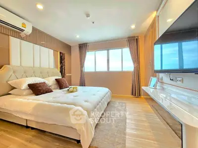 Luxurious bedroom with modern decor and large window offering natural light.