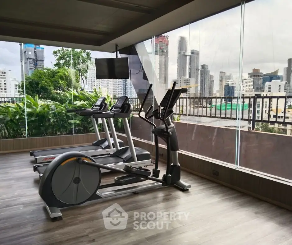 Modern gym with city view in luxury apartment building