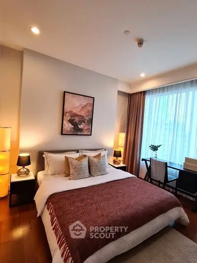 Luxurious bedroom with elegant decor and large window, perfect for relaxation and comfort.