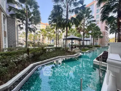 Luxurious apartment complex with stunning pool and lush palm trees