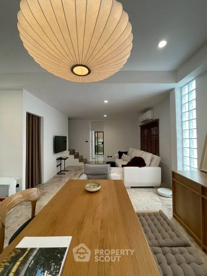 Modern living room with stylish lighting and cozy seating area, perfect for relaxation and entertainment.