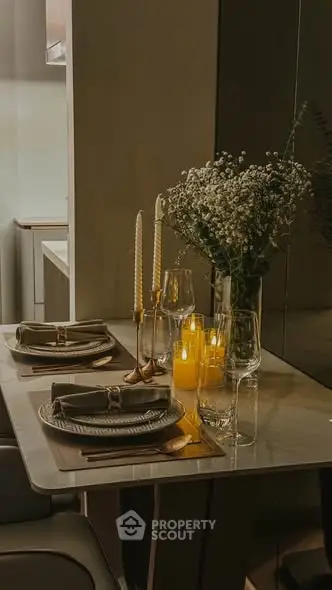 Elegant dining setup with candles and flowers in a modern kitchen