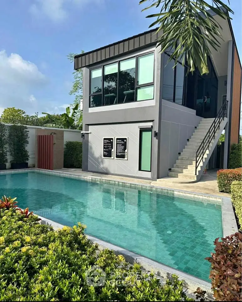 Modern two-story house with private pool and lush garden