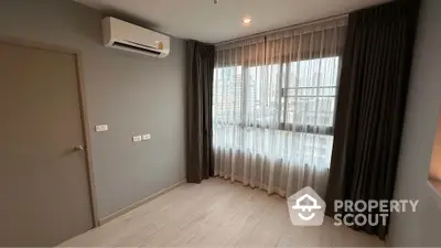 Modern empty room with large window and air conditioning in high-rise building