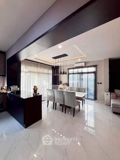 Luxurious open-plan living and dining area with modern kitchen and elegant decor