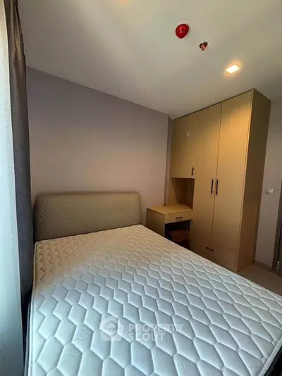 Cozy bedroom with modern wardrobe and comfortable mattress, perfect for restful nights.