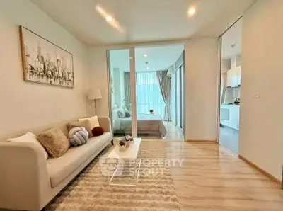 Modern open-plan living room with cozy decor and natural light