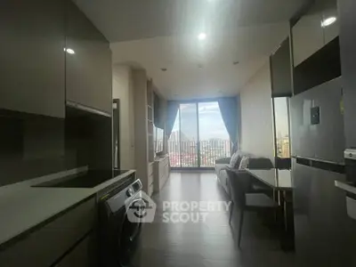 Modern apartment with open kitchen and city view from large windows.