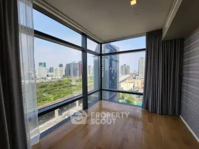 Spacious corner unit with floor-to-ceiling windows offering a stunning city view, perfect for urban living.