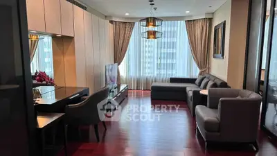 Elegant living room with modern furniture and large windows offering city views.