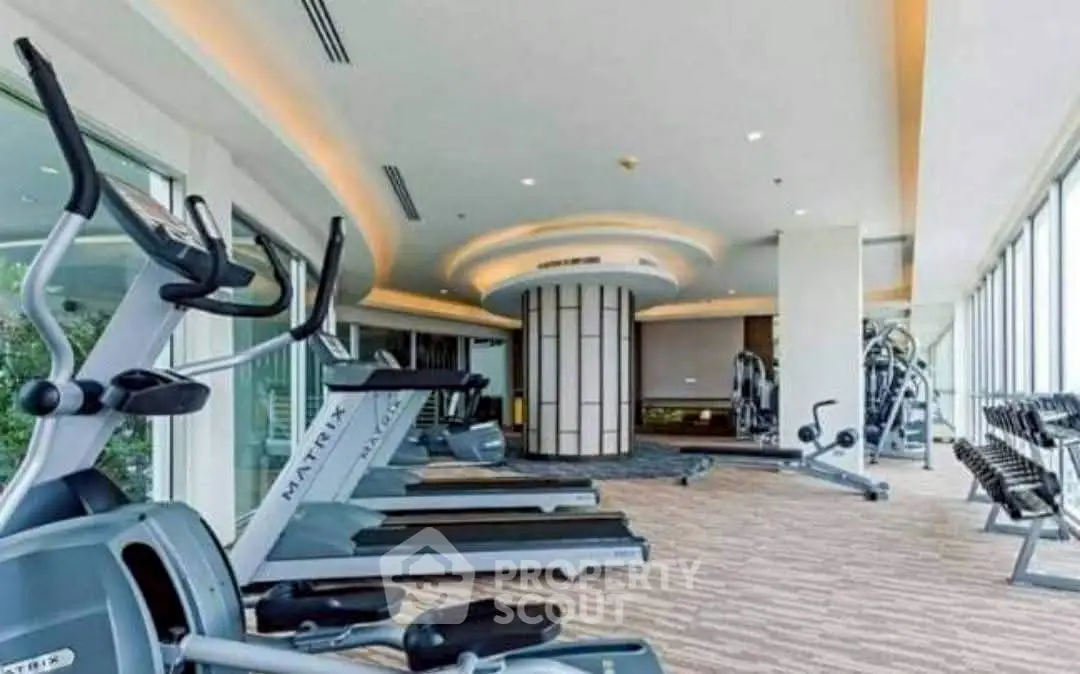 Spacious modern gym with state-of-the-art equipment and panoramic windows.