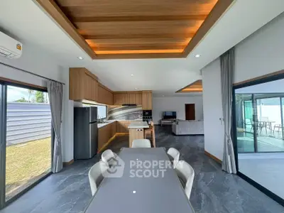Modern open-plan kitchen and dining area with sleek design and natural light