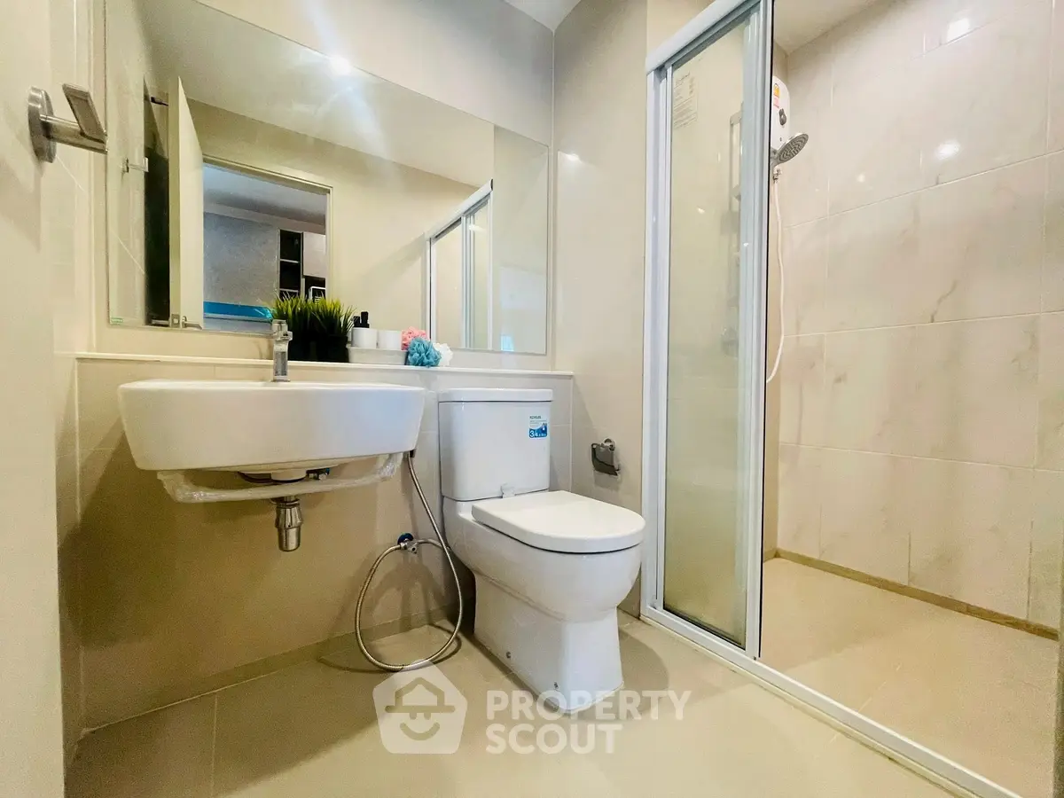 Modern bathroom with sleek fixtures and glass shower enclosure
