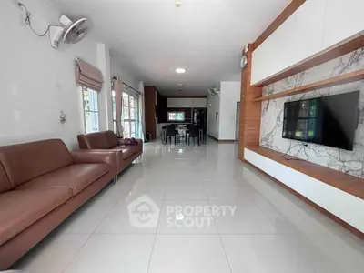 Spacious modern living room with sleek furniture and open layout, perfect for family gatherings.