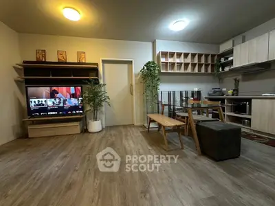 Modern open-plan living room with stylish kitchen and wooden flooring