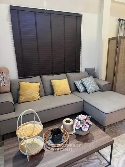 Stylish living room with modern gray sofa and chic decor accents