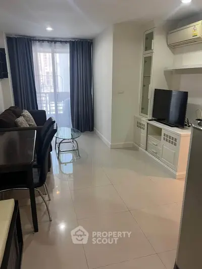 Modern living room with sleek furniture and natural light in a stylish apartment.