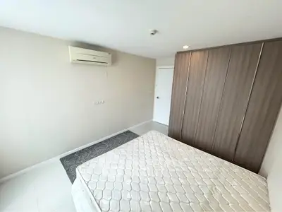 Spacious bedroom with modern wardrobe and air conditioning in a stylish apartment.