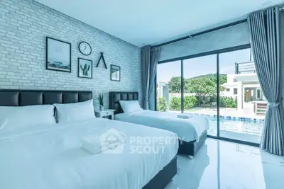 Luxurious bedroom with pool view, featuring twin beds and modern decor, perfect for relaxation and comfort.