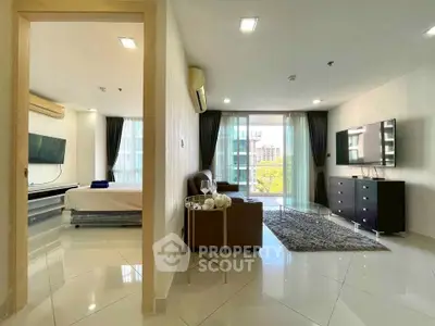 Spacious modern living room with open layout and large windows offering natural light.