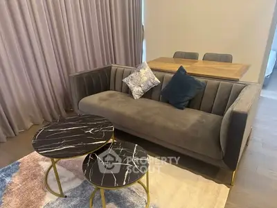 Stylish living room with modern sofa and chic marble coffee tables