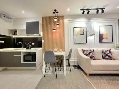 Modern open-layout kitchen and living room with stylish decor and cozy seating area.