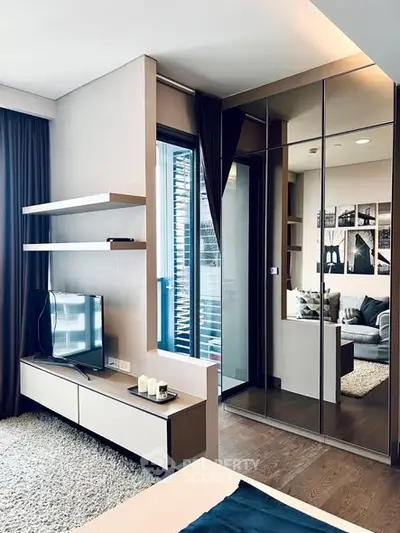 Modern living room with sleek design and mirrored wardrobe