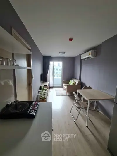 Modern compact living room with balcony view and sleek furnishings