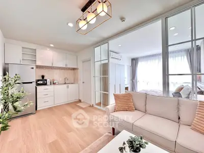 Modern open-plan living room and kitchen with elegant decor and natural light