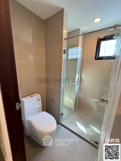 Modern bathroom with glass shower and sleek tile design
