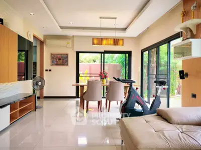 Spacious modern living room with exercise bike and elegant dining area