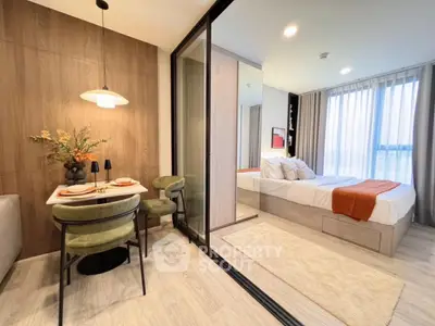 Modern apartment with stylish dining area and cozy bedroom, featuring elegant decor and natural light.