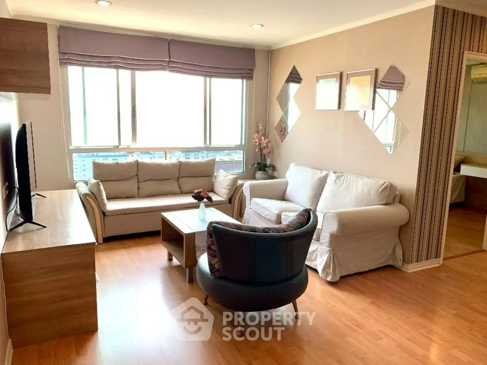 Bright and cozy living room with modern furniture and large windows.