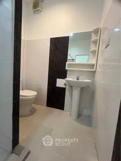 Modern bathroom with sleek design and pedestal sink