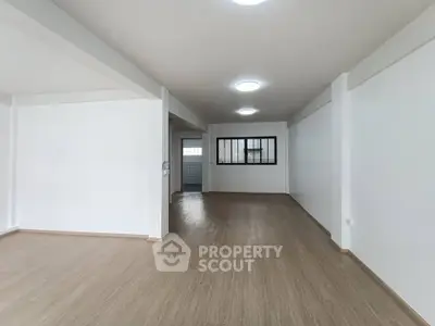 Spacious open-plan living area with modern flooring and ample natural light.