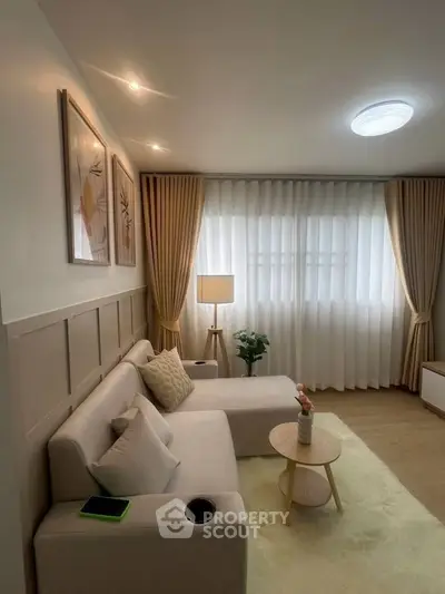 Cozy living room with modern decor, soft lighting, and elegant curtains, perfect for relaxation.