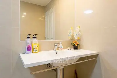 Modern bathroom with sleek sink and stylish decor, perfect for contemporary living.