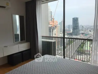 Modern bedroom with city view and large windows in high-rise apartment