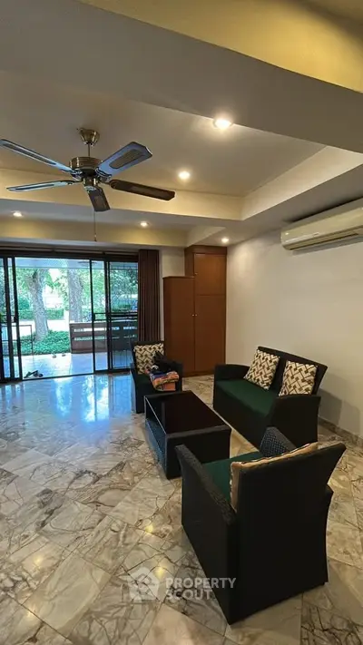 Spacious living room with marble flooring and garden view