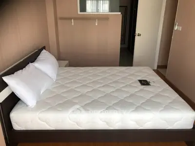 Spacious bedroom with a comfortable double bed and modern decor, perfect for relaxation.
